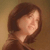 Pixelated close-up of a person's head and shoulder with brown hair against a muted brown background.