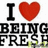 Pixelated graphic with black text 'I' and 'BEING FRESH' surrounding a red heart symbol on white background.