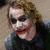 A collage of Batman and Joker characters with a bat symbol, featuring pixelated images in various poses and expressions.