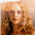 A static image shows a person with long curly light brown hair against a soft beige background, next to green text reading 'Original Icons .com' on dark green.