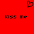 Red background with black pixelated heart symbol above two identical "Kiss me" text phrases in blocky font.