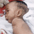 A static image shows a baby lying on a white blanket with a red object partially visible, accompanied by orange pixelated text reading "My Bestest Boyfriend!".