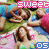Pixelated image of two people lying on grass with text overlays, one person in blue shirt and pink shorts, the other in white dress.