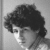 Black-and-white image of a person with curly hair in four showing slight head position changes and a '<3' symbol in the bottom-right