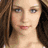 A pixelated image of a person with long brown hair and light skin, next to green text reading 'Original Icons .com' on a dark background.