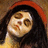 Pixelated close-up of a person with dark hair wearing a red headband, light skin, and a yellow garment, set against a brown background.