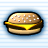 Pixelated cheeseburger with sesame seed bun, melted yellow cheese layer, and brown patty on light blue striped background.