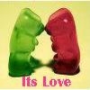 Two glossy, rounded shapes in green and red form a heart shape against a pale yellow background with pink text reading 'Its Love' below.