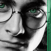 Close-up of a person's face with round eyeglasses, green eyes, and a neutral expression, featuring a green vertical bar on the right edge.