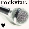 Black text 'rockstar.' above a silver microphone with a mesh grille and black accents, a black heart symbol in the bottom-left corner.