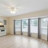 A pixelated static image of an interior space with large windows, columns, and a light-colored ceiling.