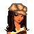 Pixel-art cartoon doll with long brown hair, wearing a beige cap, striped crop top, and beige pants, standing with hands on hips.