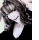 A woman with long curly brown hair appears in multiple poses across a of images, wearing various outfits including black tops and a green dress