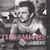 Pixelated grayscale image of a shirtless man with dark hair and beard, holding an object near his face, with pink text at the bottom.