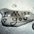 A black background displays white text and heart symbols with a small grayscale image of a person wearing a cap on the left, and a red scribbled heart with 'R.I.P.' in bold letters on the right.