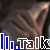 Animated sequence of a brown tabby cat's face with striped fur, overlaid by blue and white pixelated text reading 'lll.Talk' in repeating frames.