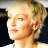 Static 48x48 pixel buddy icon showing a close-up of a person's face with short blonde hair, closed eyes, and light skin tone against dark background.