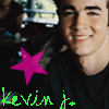 Static buddy icon featuring a person in dark clothing with a pink star and green text overlay, background includes blurred vehicle and indistinct figures.