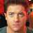 Static 48x48 pixel buddy icon showing a close-up of a person's face with brown hair and light skin, rendered in low-resolution pixel art style against a dark background with red accents.