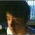 A person with dark hair and a white shirt appears in four showing slight head movement against a blurred background