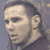 Pixelated static image of a person's face in profile view with visible hair, ear, and neck against a gray background.