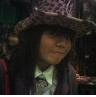 A four- shows a person in a patterned hat and dark clothing, a textured map-like image with Chinese characters, a close-up of a person with dark hair, and a blank