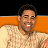 Pixelated image of a person with short dark hair wearing a light-colored shirt, smiling against an orange and black background.