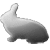 Pixelated grayscale image of a rabbit-like creature with a rounded body, short limbs, and a raised tail, set against a solid light gray background.