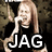 Pixelated image of a person with long light brown hair wearing black clothing, holding an object near their face against a dark background.