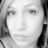 Pixelated grayscale portrait of a person with dark hair, neutral expression, and visible facial features including eyes, nose, and mouth.