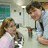 A pixelated image of two people in a lab setting with text overlays reading 'sigh...' and 'young love <3' on black and gray backgrounds.