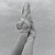 Pixelated grayscale image of a figure with raised arms against a light gray background, showing partial facial features and clothing details.
