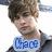 A pixelated image of a person with brown hair and blue eyes, wearing a dark gray shirt against a bright background.