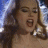 A 3-frame animated contact sheet showing a woman with long brown hair singing or shouting in close-up, displayed on a gray background.
