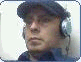 A person wearing a dark cap and headphones appears in a of showing sequential facial expressions and head movements