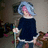 Pixelated image of a person with light blue hair holding a staff, split into four quadrants with green and gray backgrounds and blue text.