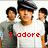 A pixelated image of five people in white and gray shirts with black berets, overlaid with red text reading "I adore the Jonas Brothers".