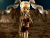 Pixelated image of a person with light hair in pigtails wearing dark red clothing against a brown and blue background.