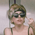 A person with short brown hair and dark sunglasses holds a finger near their temple in a static pose across four