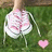 A pair of pink and white sneakers on grass with a small pink heart, showing subtle animation changes in the heart's position.