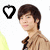 Pixelated image of a person with short brown hair wearing a brown jacket over a light shirt, with a black heart outline above the head on a white background.