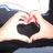 Two hands form a heart shape with a black interior, with red text appearing sequentially over the heart.