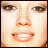 Pixelated close-up of a human face showing eyes, nose, and mouth with light skin tone and brown hair visible at the bottom edge.