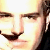 Pixelated close-up of a person's face showing eyes, nose, and mouth with light skin tone and dark hair on the right side.