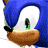 Pixelated blue character with white face and green eyes, holding a brown object against a gray background.