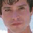 Four pixelated portrait of a person with short brown hair, varying facial expressions and backgrounds in a