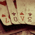 four identical showing a stack of cards with 'LOVE' text and red symbols on a beige background