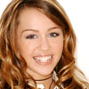 A close-up portrait of a person with light brown wavy hair, wearing a dark choker necklace and a white top with a collar, against a plain white background.