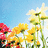 Pixelated image of sunflowers and red flowers against a light blue sky background.