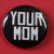 Pixelated circular icon with black background and white text reading 'YOUR MOM' on red backdrop.